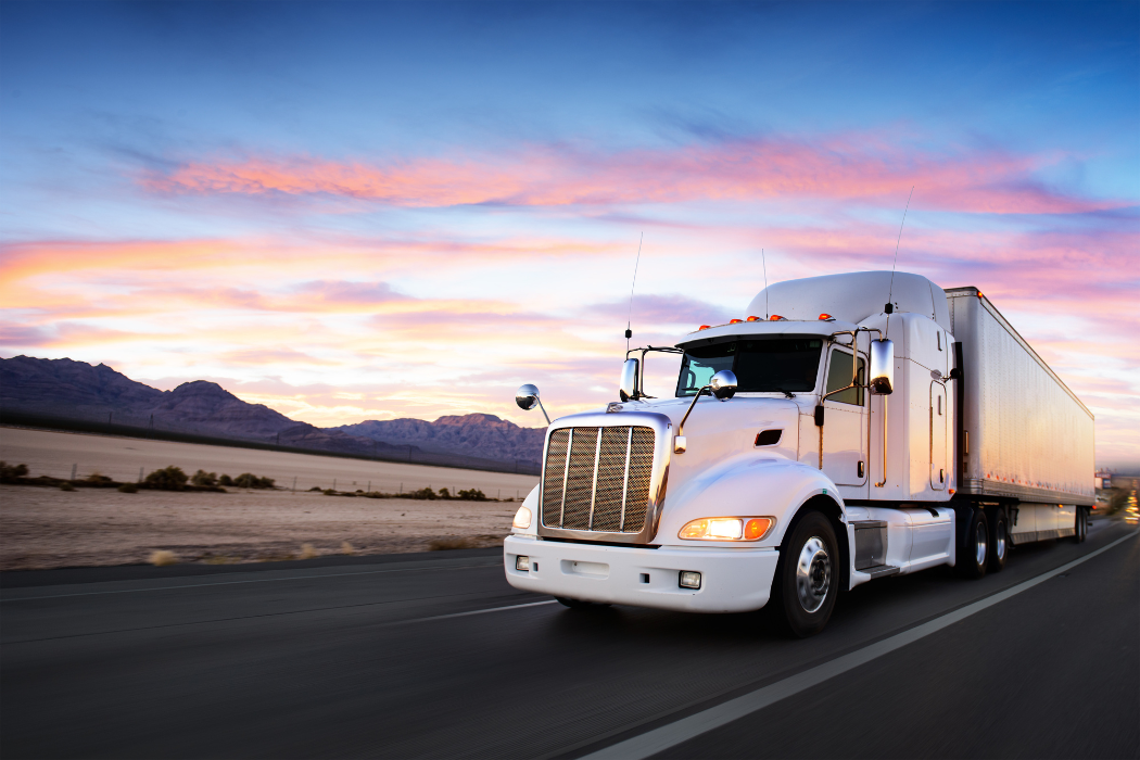 White truck driving at sunset