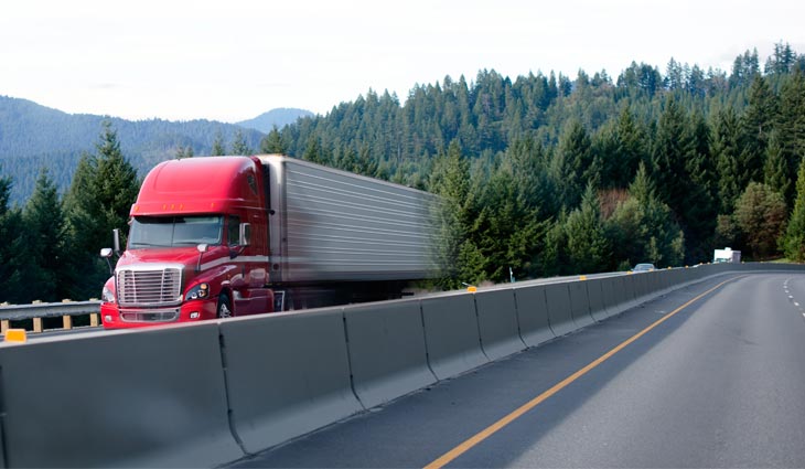 Red and white semi truck over the road shipping