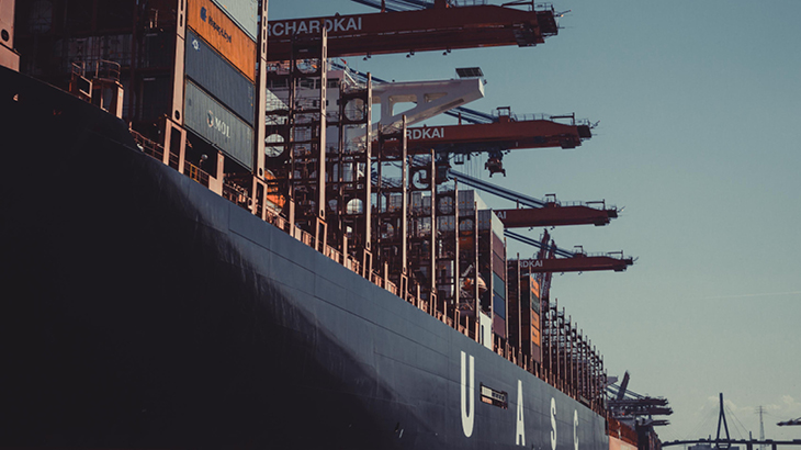 steam ship docked at port with containers