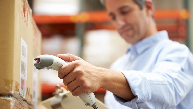 warehouse worker scanning barcode on a shipment