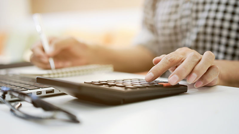 person checking figures on a calculator